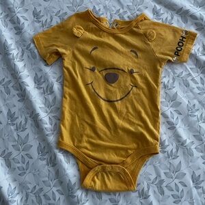 Disney Yellow Pooh Bear Bodysuit comes with a cap